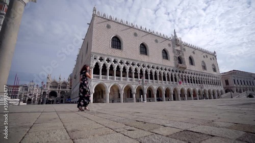 Wallpaper Mural Atractive young woman walking on Square San Marco in Venice Italy looking at Palazzo Ducale Torontodigital.ca