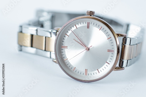 The female wrist watch isolated on a white background. Elegant mechanical wristwatch made of silver metal. Hand Watch close up.