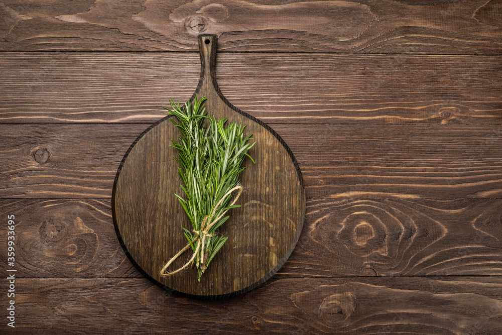 Fresh rosemary sprigs on rustic kitchen table Fresh rosemary sprigs on rustic kitchen table