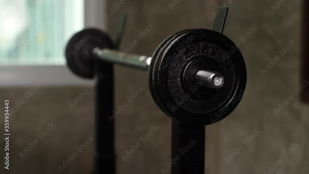 Hand of trainer or a man setup weight of dumbbell to prepare exercise at home gym. Hand of trainer or a man setup weight of dumbbell to prepare exercise at home gym.