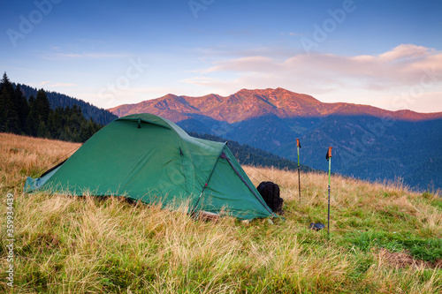   amping tent in mountains at sunrise