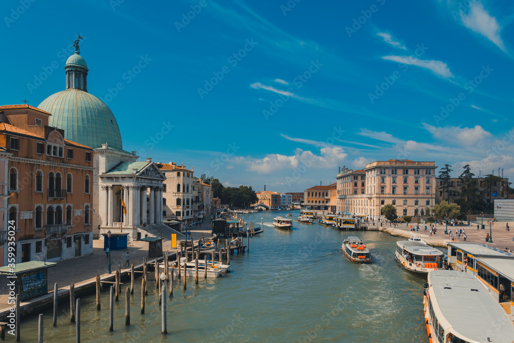 Grand canal in Venice, Italy, with traffic of boats, during a sunny day with clear sky in summer