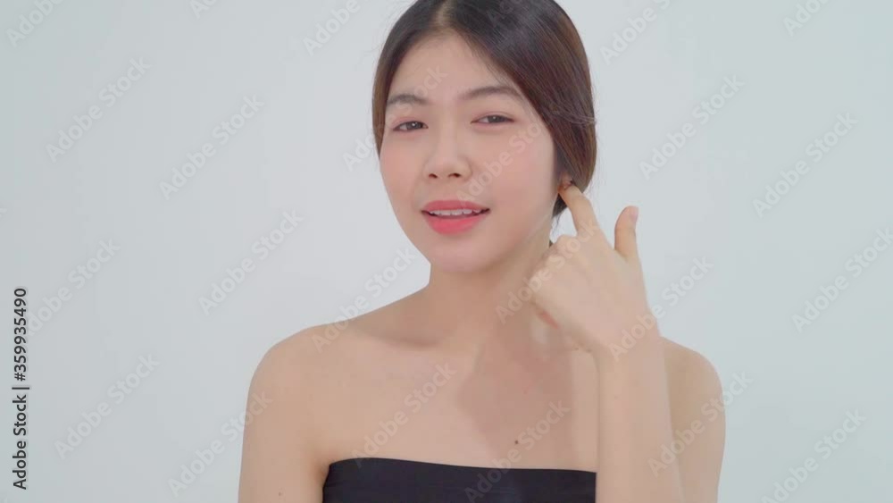 Close up beauty portrait of beautiful young Asian woman touching face and healthy skin in isolate white studio background. People with healthcare and beauty concept. Close up beauty portrait of beautiful young Asian woman touching face and healthy skin in isolate white studio background. People with healthcare and beauty concept.