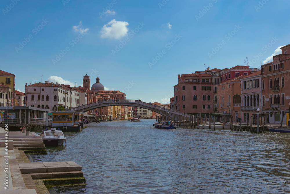 View of a bridge over the grand canal in Venice, Italy, with boats