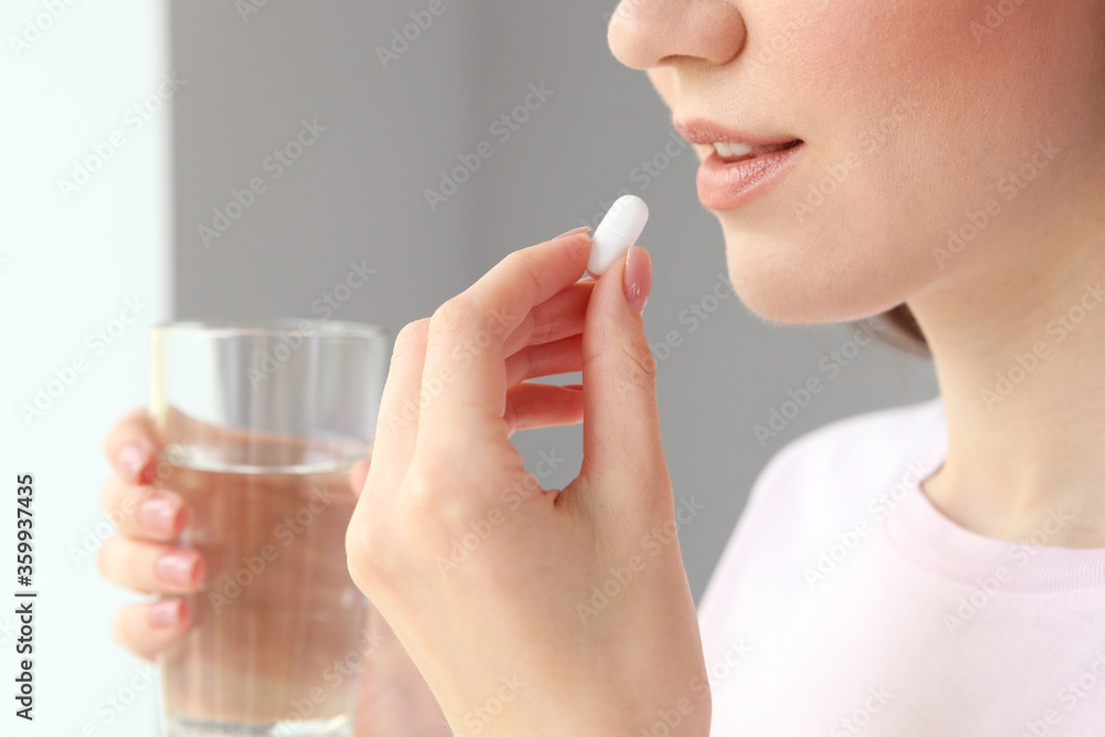 Young girl in a good mood takes pills at home
Young girl in a good mood takes pills at home