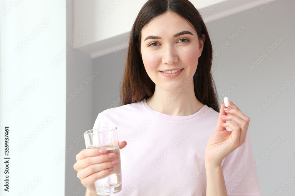 Young girl in a good mood takes pills at home
Young girl in a good mood takes pills at home