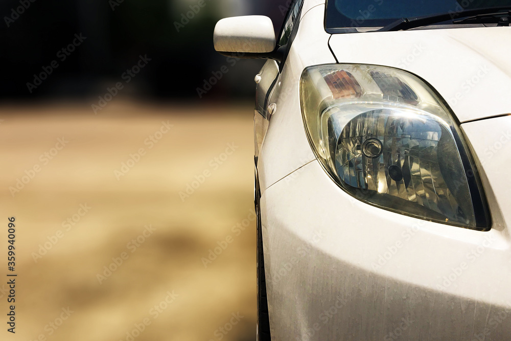 close up front view of white car is outdoor with bokeh background