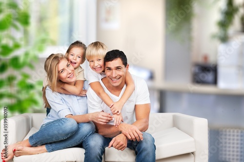 Beautiful smiling lovely family sitting on the sofa