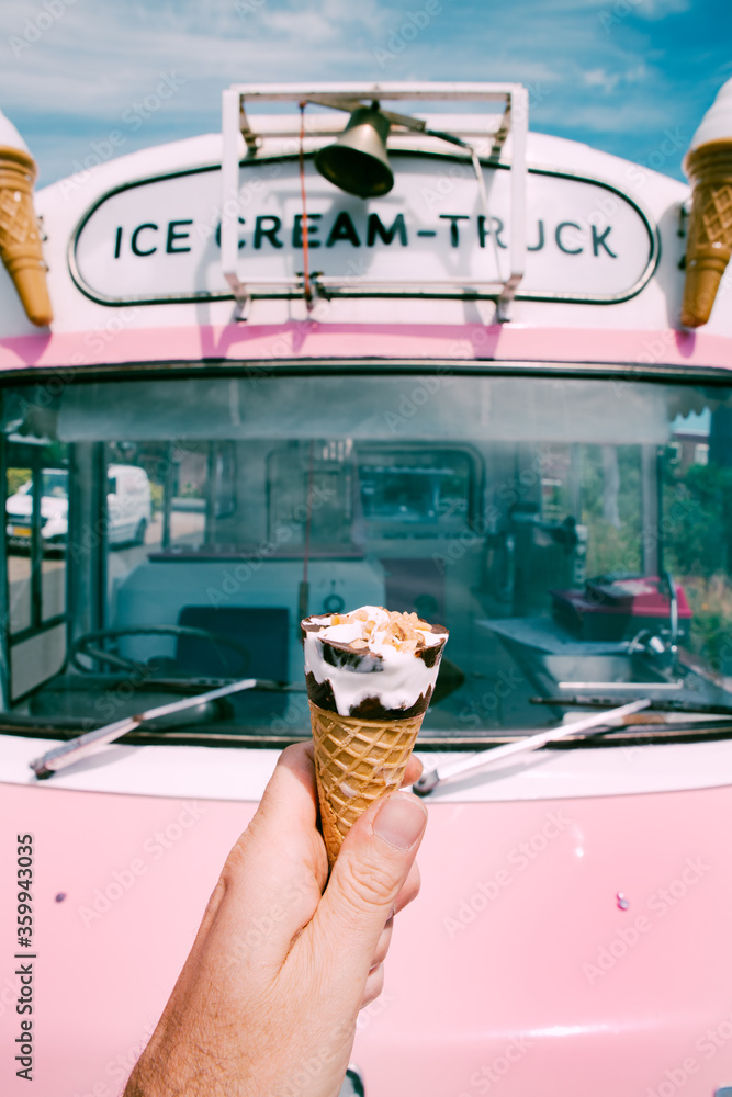 Ice cream cone with a pink retro ice cream truck or van in the