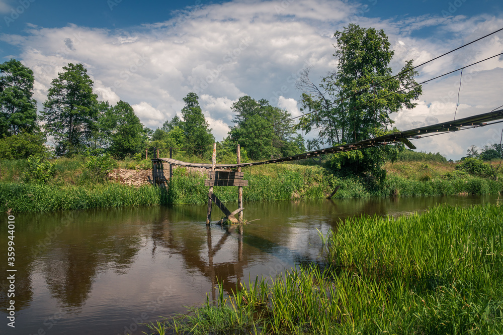 Wooden bridge over the Liwiec river at sunny day Korytnica, Masovia, Poland