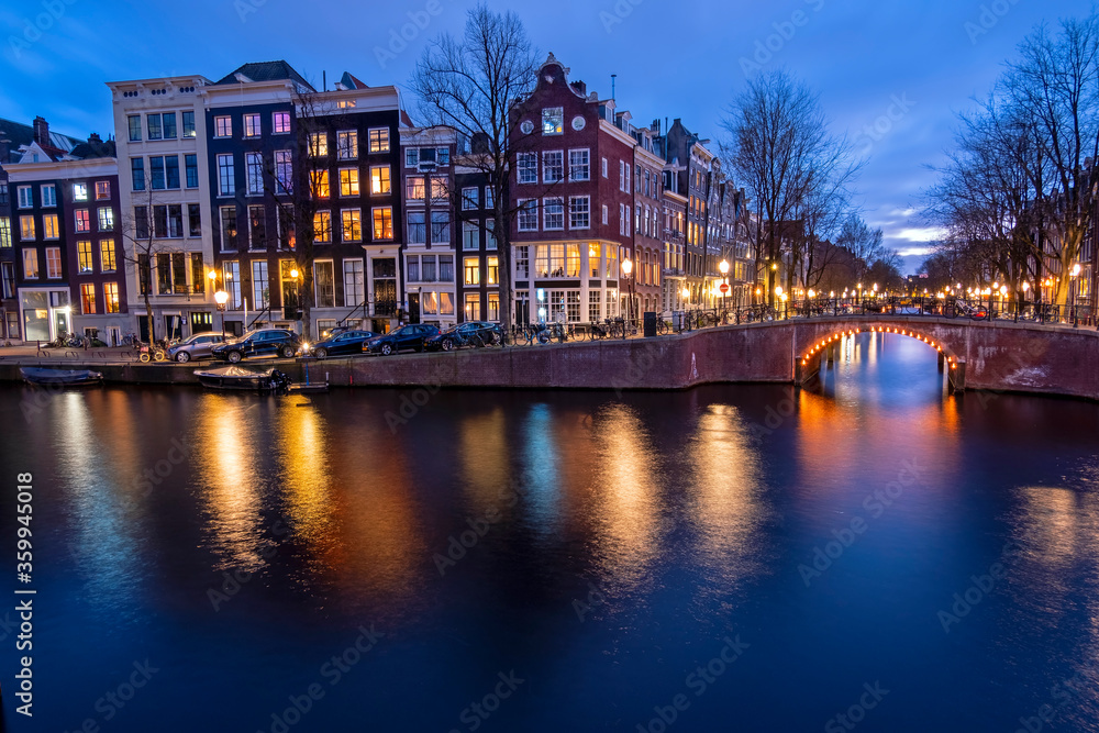 Amsterdam houses along the canal at night in the Netherlands