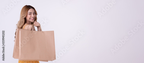 Happy asian woman holding shoppingbag with mid year sale. photo