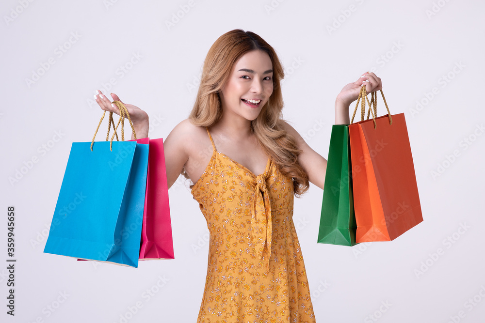 Happy asian woman holding shoppingbag with mid year sale.