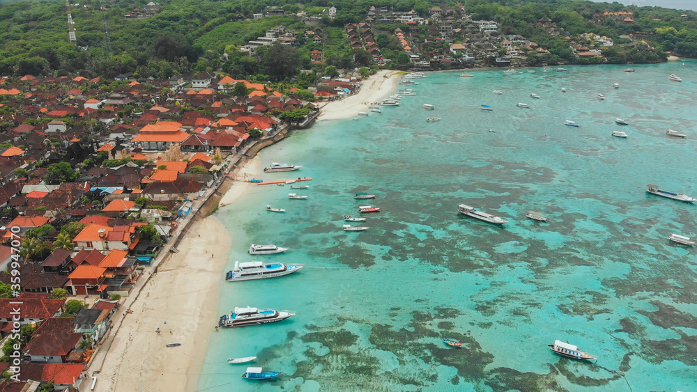 Coast Jungut Batu village with boats on the island of Lembongan. Indonesia. Aerial view.