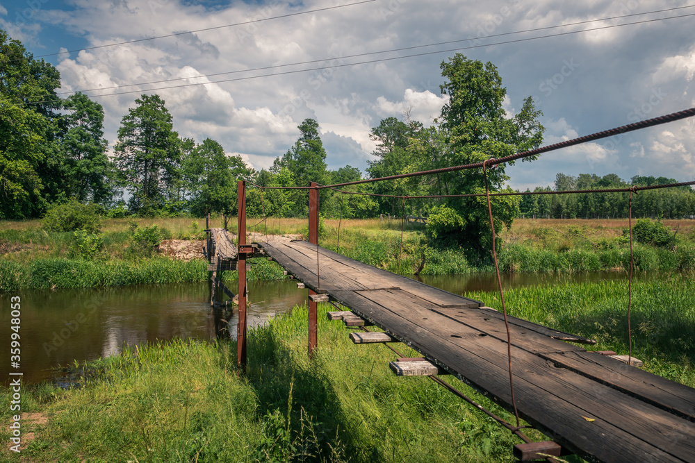 Wooden bridge over the Liwiec river at sunny day Korytnica, Masovia, Poland