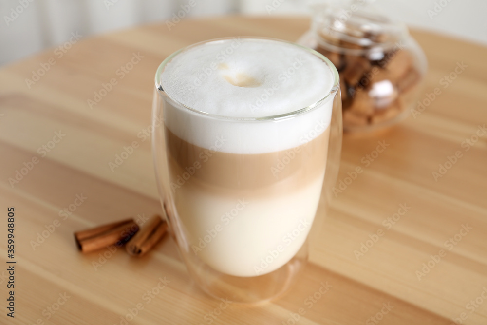 Delicious latte macchiato in glass on wooden table Delicious latte macchiato in glass on wooden table