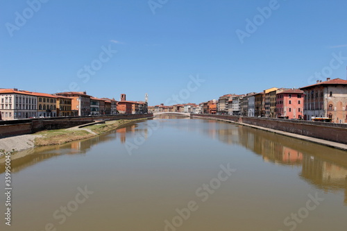 The Arno river and the Conte Ugolino bridge called Ponte di Mezzo seen from Ponte della Fortezza in Pisa, Italy.