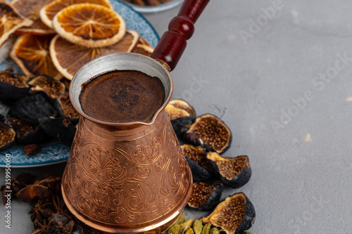 Принти на полотні Copper coffee turk with dried seeds and fruits on grey surface