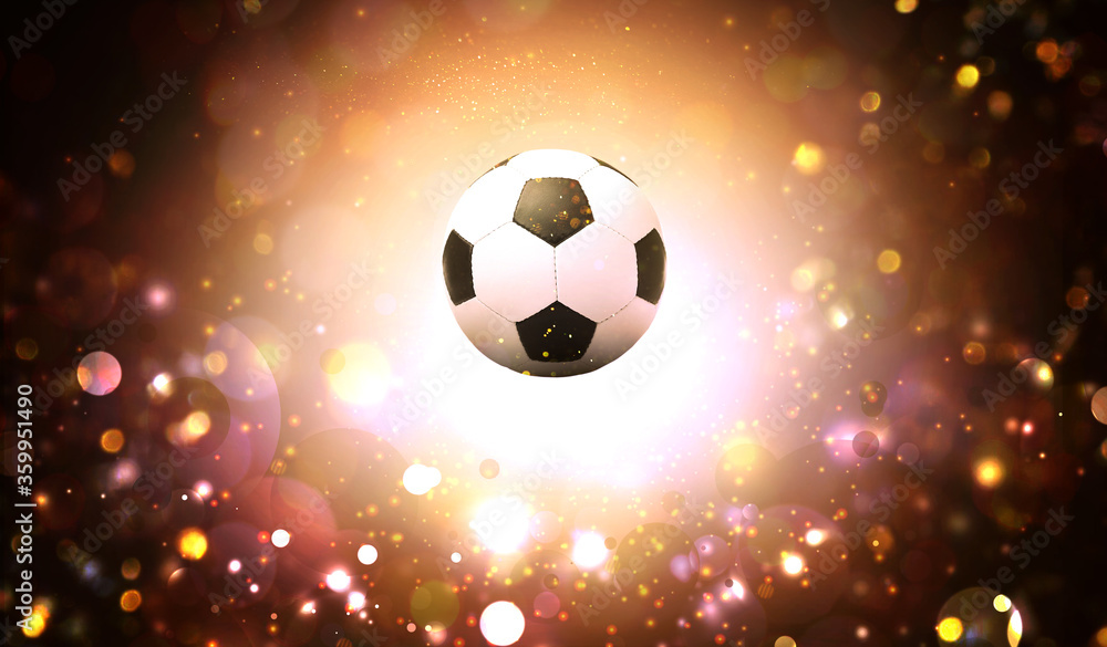 Obraz premium Soccer ball and blurred lights on dark background