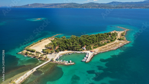Aerial drone photo of famous island of dreams or Pesonisi connecting with small road with seaside fishing village of Eretria, Central Evia island, Greece © aerial-drone