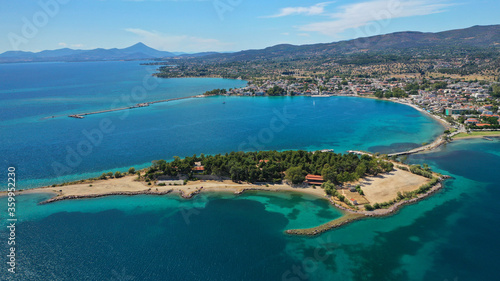 Fototapeta Naklejka Na Ścianę i Meble -  Aerial drone photo of famous island of dreams or Pesonisi connecting with small road with seaside fishing village of Eretria, Central Evia island, Greece