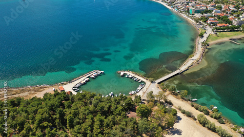 Aerial drone photo of famous island of dreams or Pesonisi connecting with small road with seaside fishing village of Eretria, Central Evia island, Greece