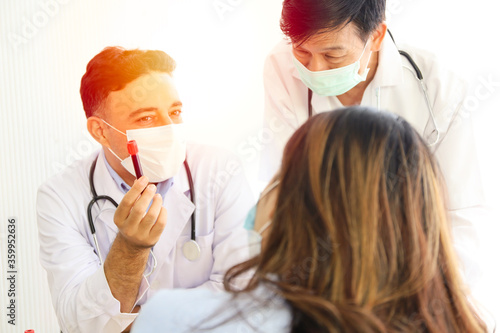 A woman or patient wear face mask and meet a doctor in hospital, headach or sick or coronar virus health checked and interview or screen, Vaccine treatment