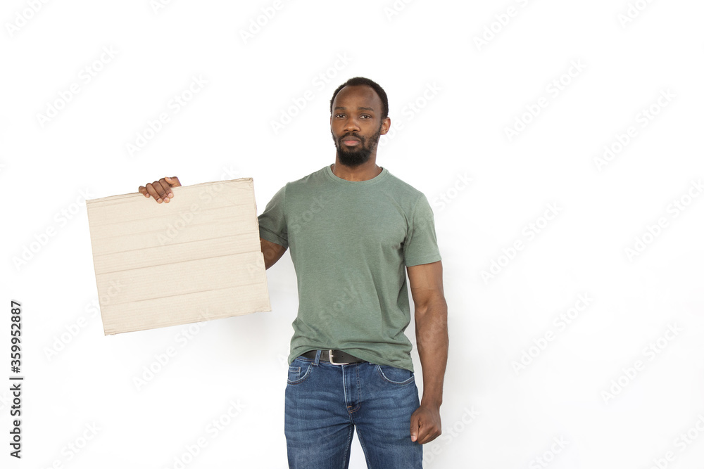 African man protesting with blank board, sign isolated on white studio background. Activism, active social position, protest, actual problems. Meeting against human rights, abusing, freedom of choice. African man protesting with blank board, sign isolated on white studio background. Activism, active social position, protest, actual problems. Meeting against human rights, abusing, freedom of choice.