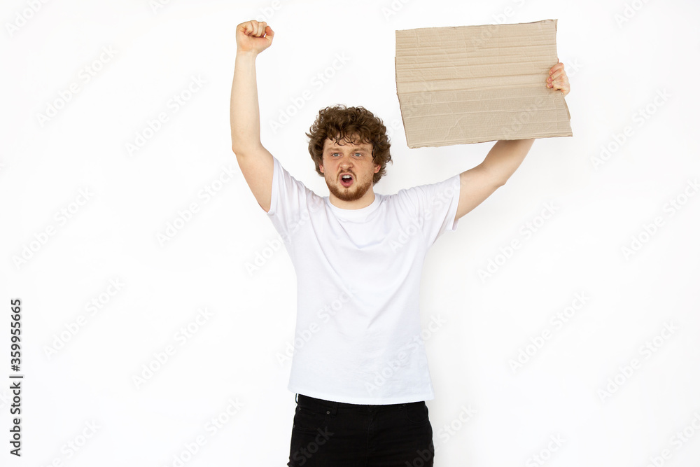 Young man protesting with blank board, sign isolated on white studio background. Activism, active social position, protest, actual problems. Meeting against human rights, abusing, freedom of choice. Young man protesting with blank board, sign isolated on white studio background. Activism, active social position, protest, actual problems. Meeting against human rights, abusing, freedom of choice.