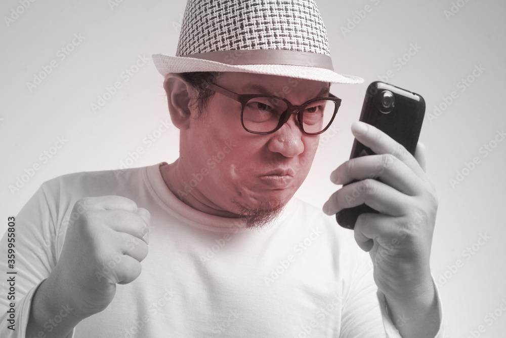 Young Man Getting Bad News on Phone, Shocked and Angry Young Man Getting Bad News on Phone, Shocked and Angry
