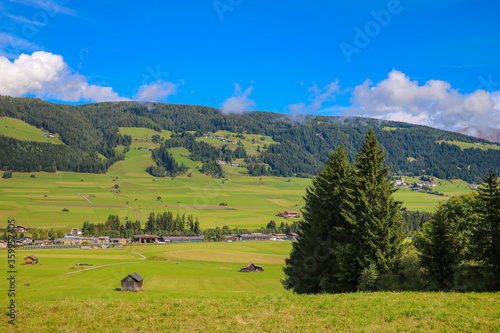 Beautiful green alpine fields. Small villages high in the mountains.