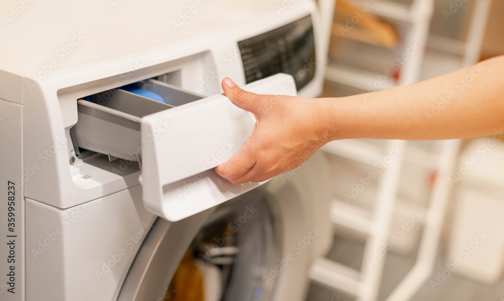 Female hand opening the washing machine and the space for detergent liquid preparing wash the clothes, Female hand opening the washing machine and the space for detergent liquid preparing wash the clothes,