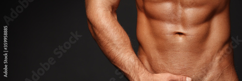 Sexy closeup portrait of handsome topless male model with beautiful eyes. Sexy man or muscular macho, bodybuilder, with muscle torso, body with six packs and abs poses on in white panties