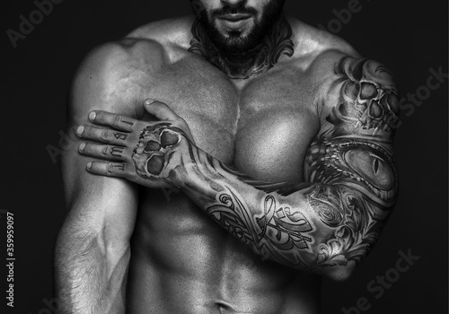 Sexy closeup portrait of handsome topless male model with beautiful eyes. Sexy man or muscular macho, bodybuilder, with muscle torso, body with six packs and abs poses on black background