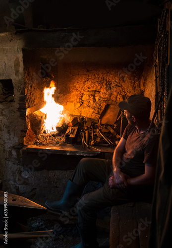 Blacksmith in front of the oven