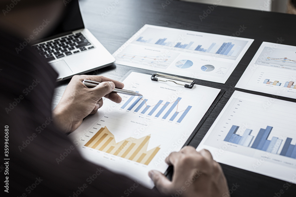 Young business men analysis graph data in the office. Young business men analysis graph data in the office.