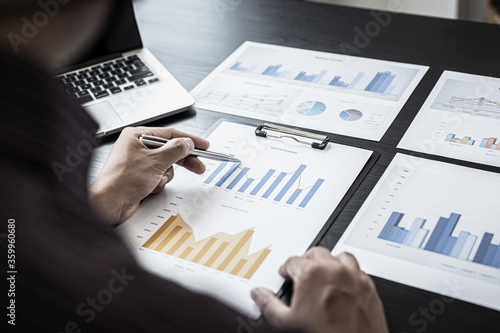 Young business men analysis graph data in the office.