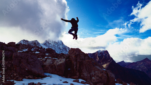 Extreme Silhouette Jumping In Air On Epic Mountain Peak Summit Success Victory Concept