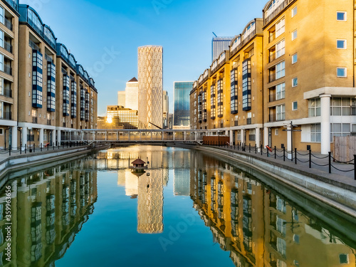 Financial district buildings in Canary Wharf area of London reflected in a lake