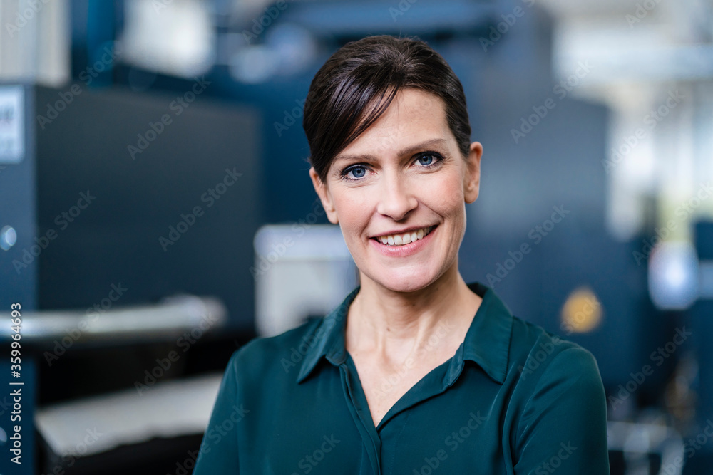 Portrait of a smiling businesswoman in a factory Portrait of a smiling businesswoman in a factory