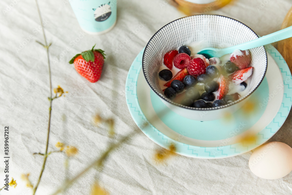 Bowl of fruit muesli and egg on breakfast table Bowl of fruit muesli and egg on breakfast table