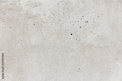 Gray concrete wall with thin cracks and holes. Industrial texture for text and pictures.