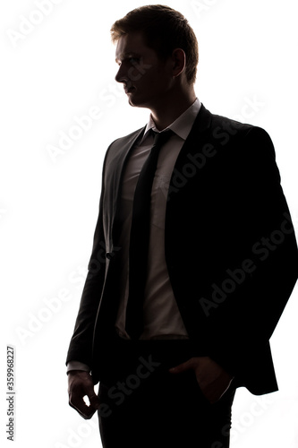 one caucasian business man handsome full suit standing full length serious silhouette in studio isolated white background