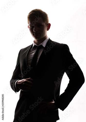 one caucasian business man handsome full suit standing full length serious silhouette in studio isolated white background