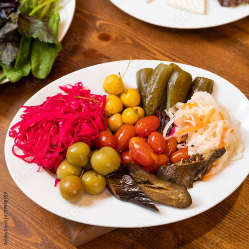 Pickled cabbage vegetables, fermented cucumbers photo