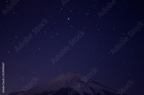 Mount Fuji with snowcap   starry night  from Lake Yamanaka  Japan