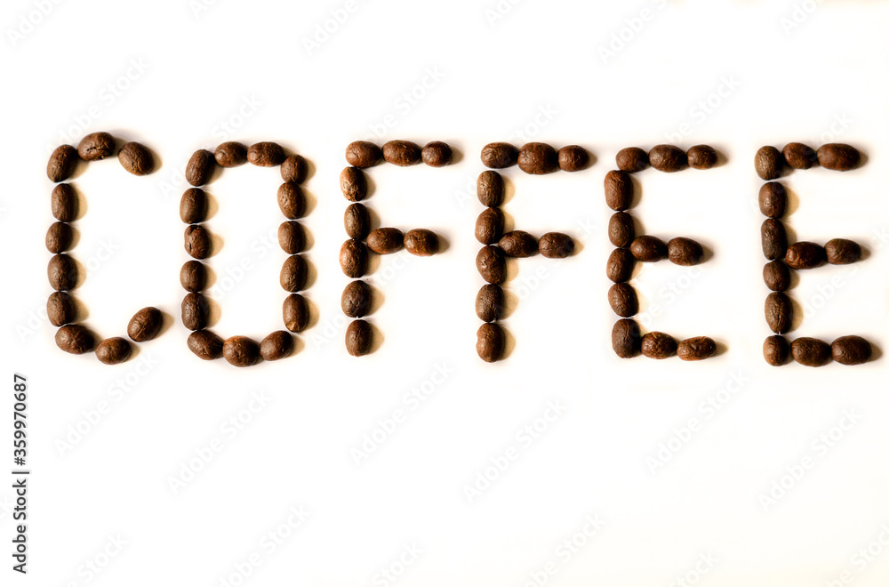 The word 'coffee' spelt out in coffee beans. Isolated against neutral white background. The word 'coffee' spelt out in coffee beans. Isolated against neutral white background.