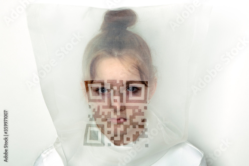 Portrait of teenage girl wearing  transparent mask with QR Code photo