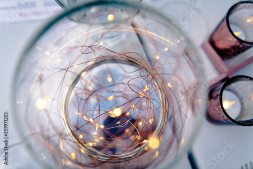 Mini light bulbs shining in glass container