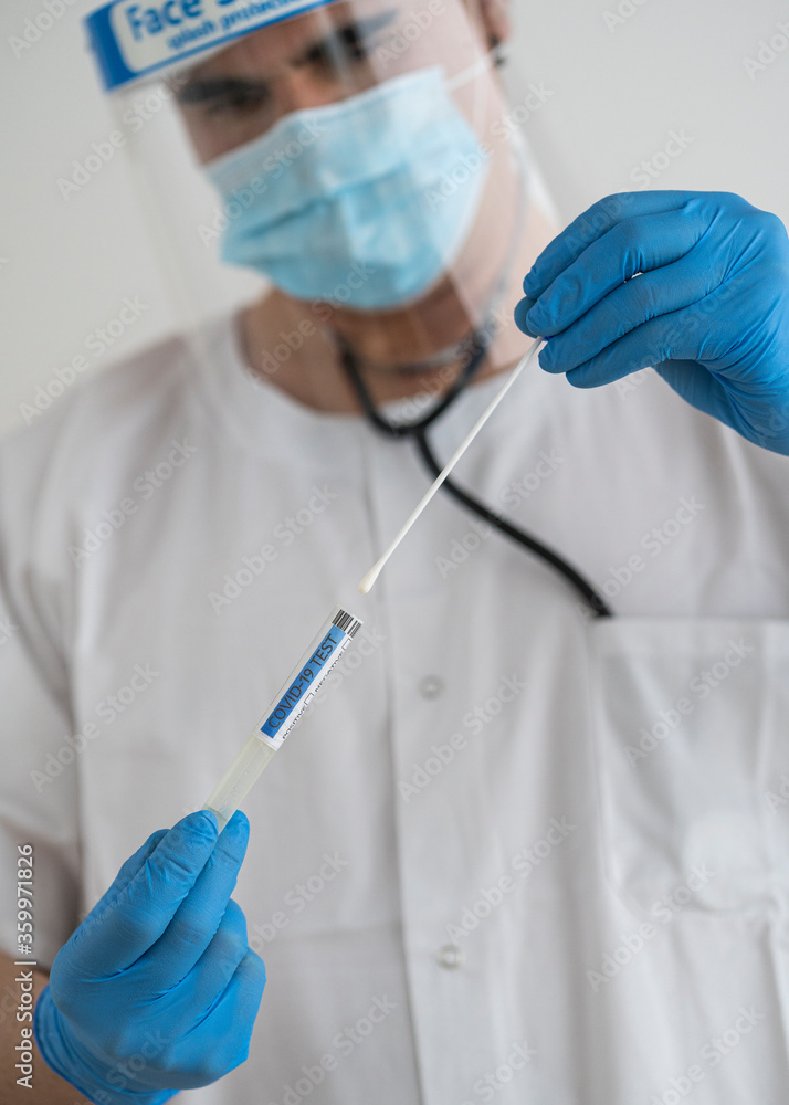 Man in protective wear taking a covid-19 swab Man in protective wear taking a covid-19 swab